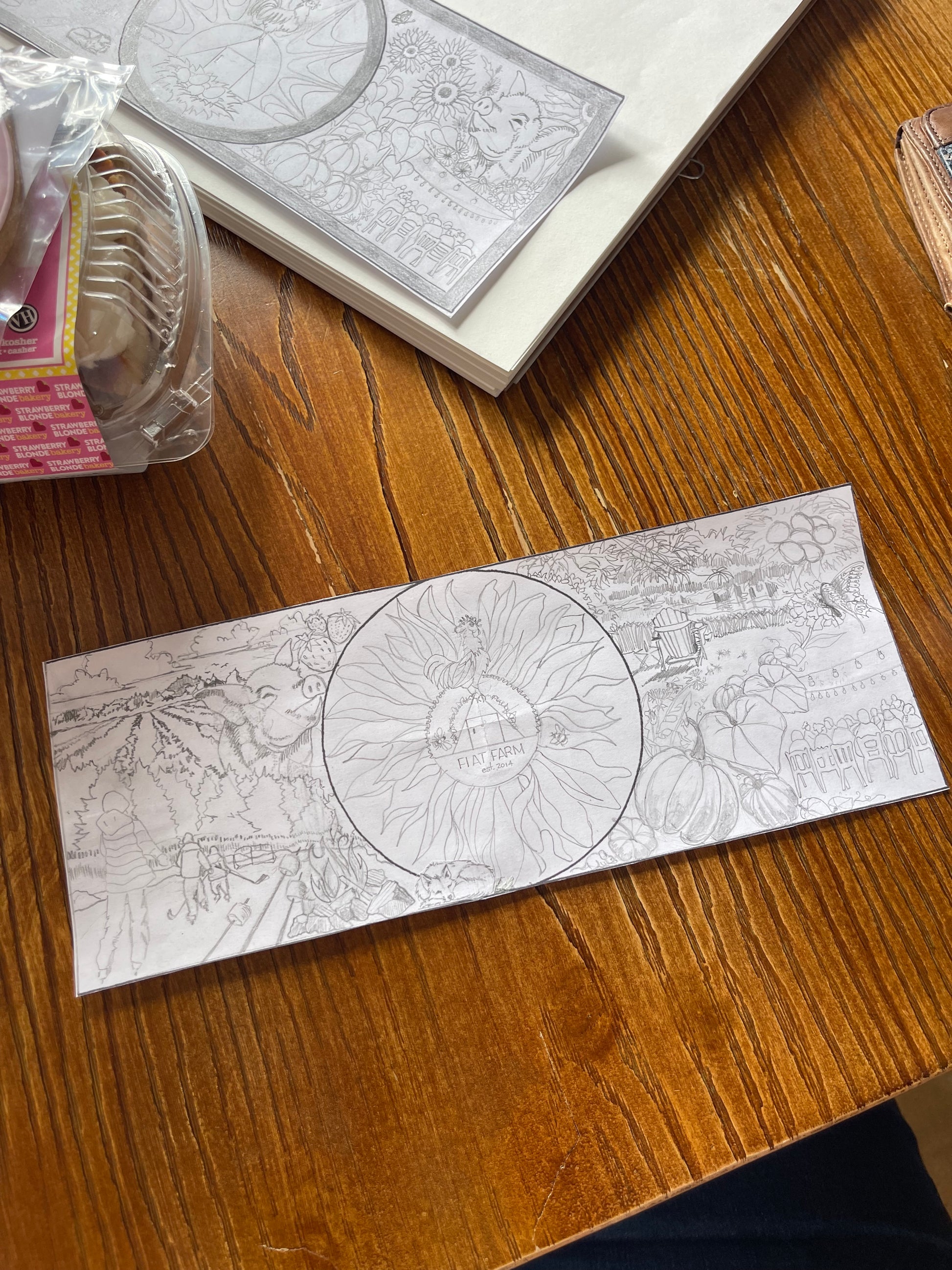 Printed design on paper with circular cutout on a wooden surface, goutart community mural